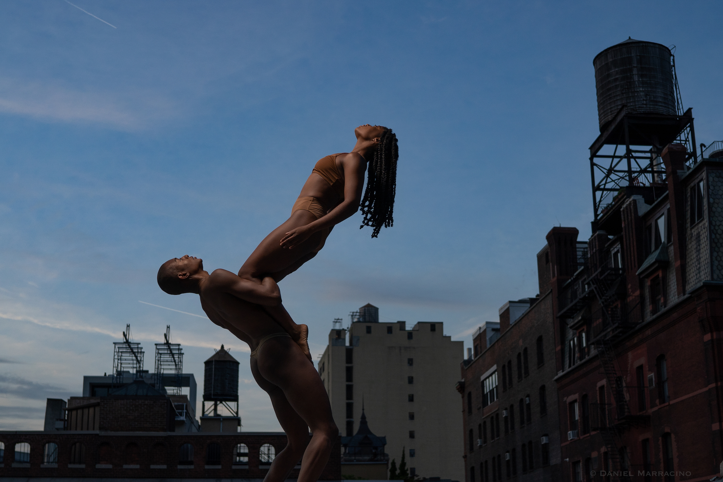 Gaspard&amp;Dancers: A dancer balances on the chest of another dancer on a rooftop in NYC. Photo by Daniel Marracino.