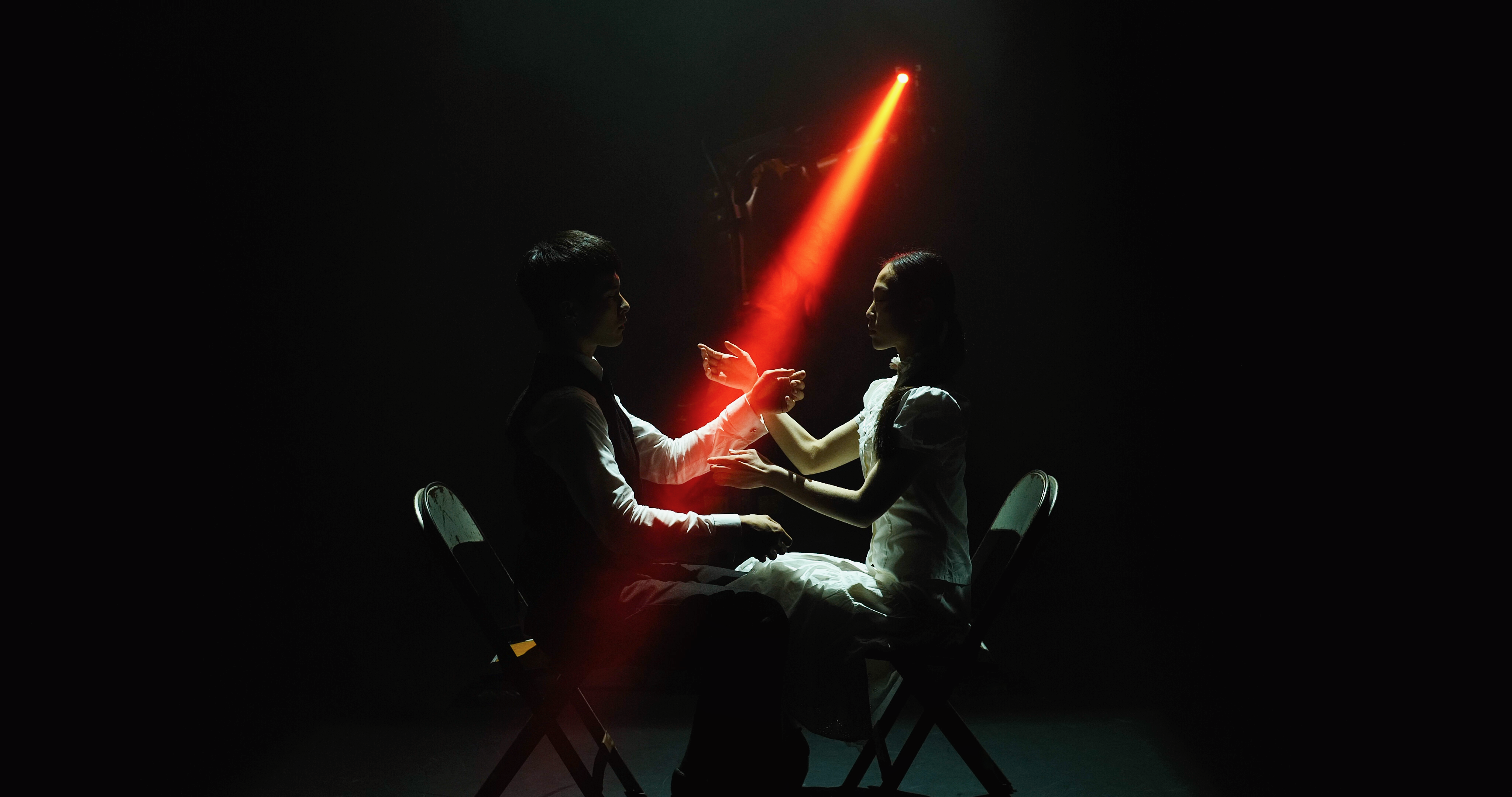 Huang Yi and another dancer on stage with a light from KUKA the robot
