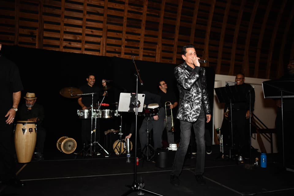 Ricardo Diquez and The Tropic Orchestra performing on stage.